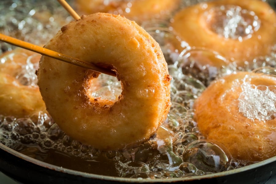donuts frying in skillet