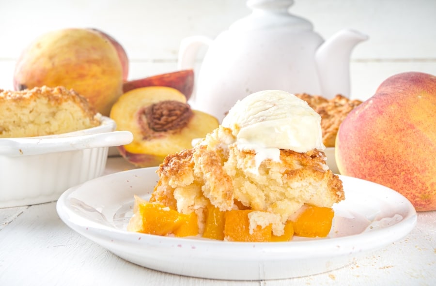peach cobbler on plate with ice cream