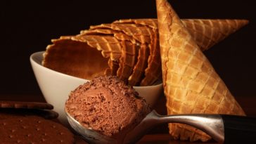 pile of ice cream cones and scoop of ice cream