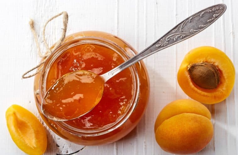 jar of apricot jam with spoon