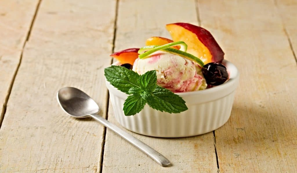 peach and cherry topped ice cream