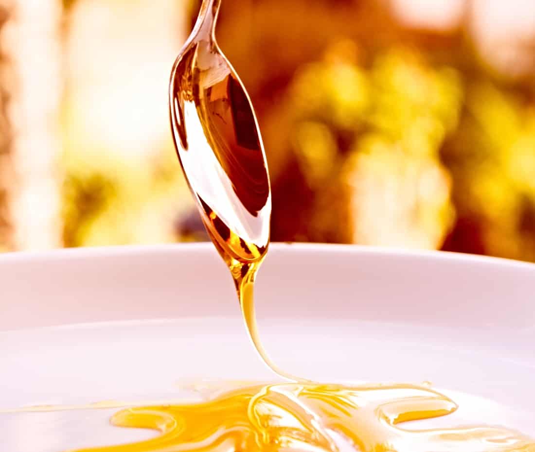 agave nectar poured from a spoon