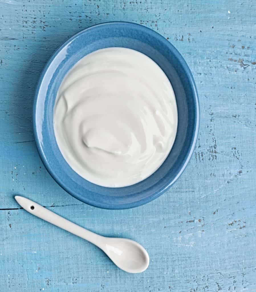 bowl of Greek yogurt on blue wood table