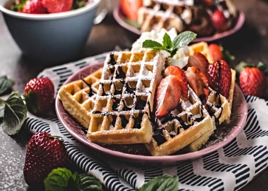 strawberry and chocolate topped waffles