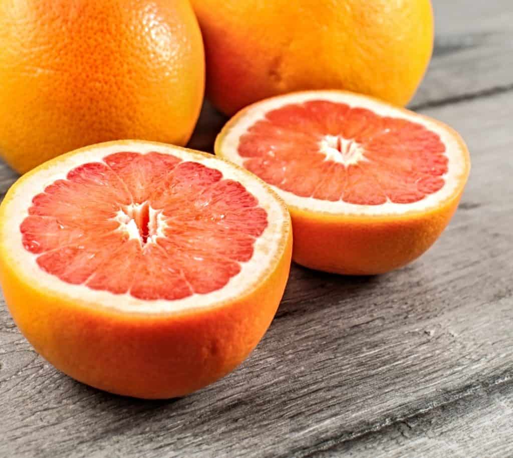 whole and sliced grapefruit on table