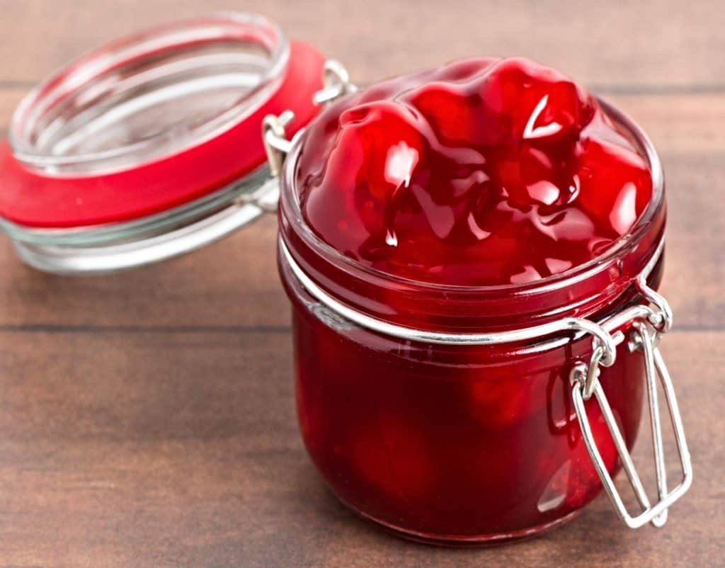 clear container of cherry pie filling