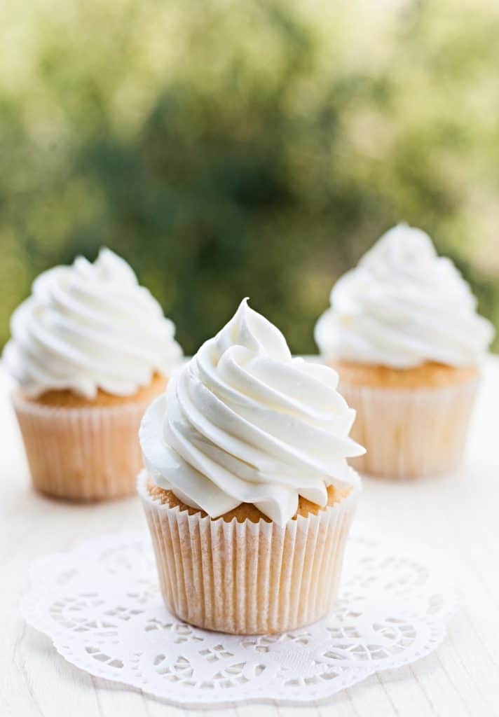 homemade cupcakes with whipped vanilla buttercream frosting