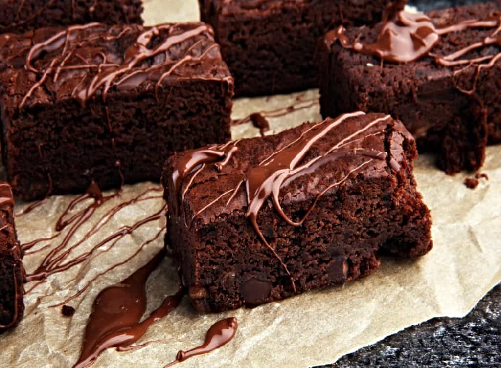 sliced chocolate brownies with chocolate syrup