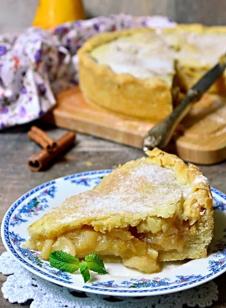 whole pear pie and slice of pear pie on table