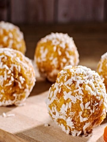 closeup of peanut butter balls rolled in coconut