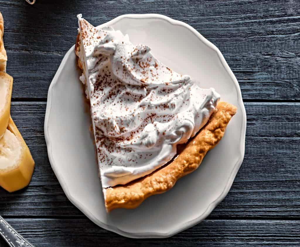 single slice of no bake caramel pie topped with whipped cream