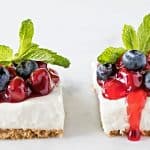 homemade cheese cake bars with berries on top