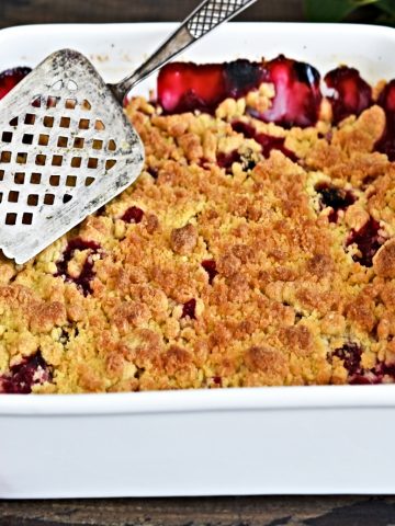 homemade old fashioned cherry cobbler in baking dish on table