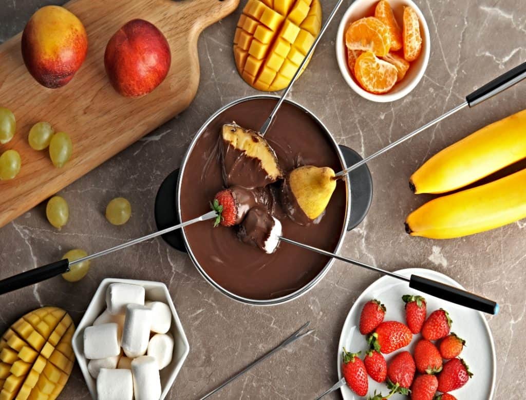 top view of chocolate ganache fondue with different types of fruit